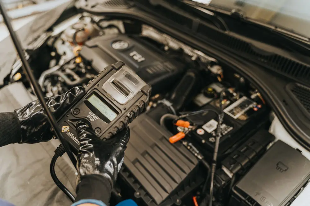 Technician carrying out vehicle diagnostics